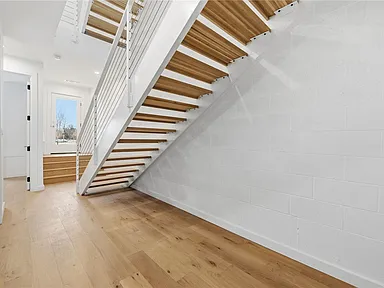 Open white oak staircase across three floors